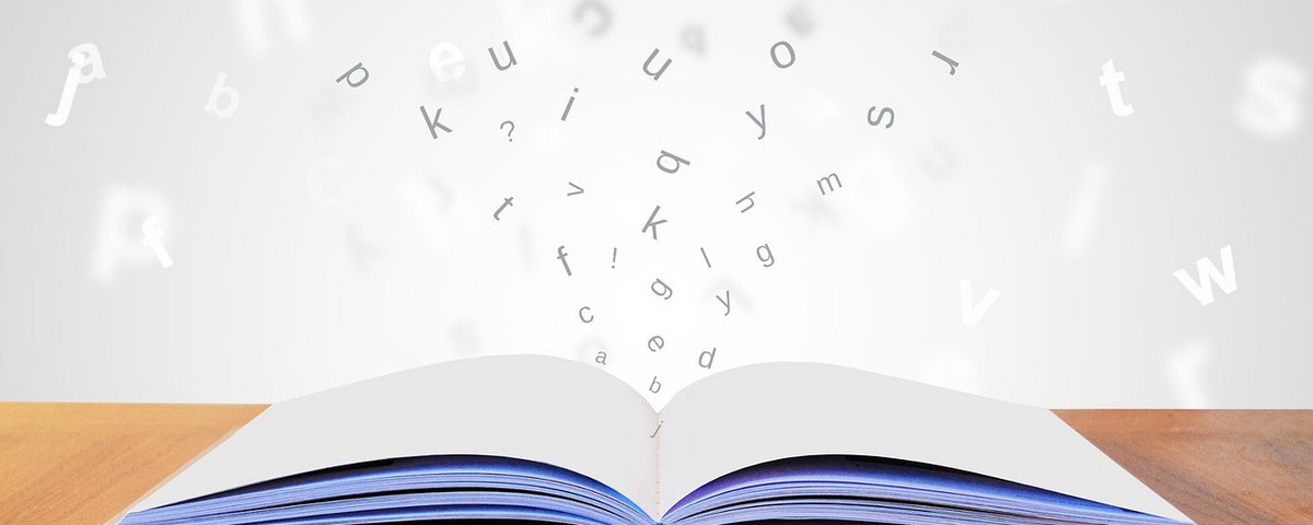Geöffnetes Buch mit Buchstaben